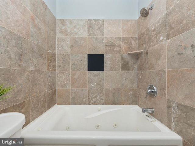 bathroom with tiled shower / bath and toilet