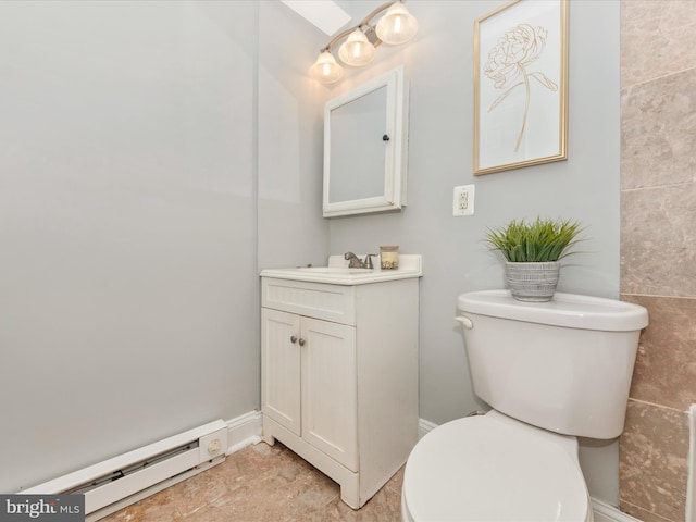 bathroom with tile walls, toilet, tile patterned floors, vanity, and baseboard heating