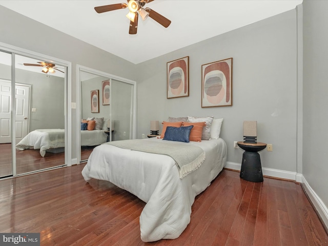 bedroom featuring multiple closets, ceiling fan, and hardwood / wood-style floors