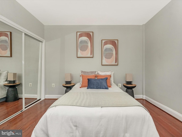 bedroom with a closet and hardwood / wood-style floors