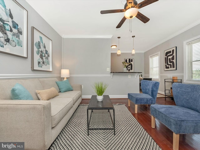 living room featuring crown molding, hardwood / wood-style floors, and ceiling fan