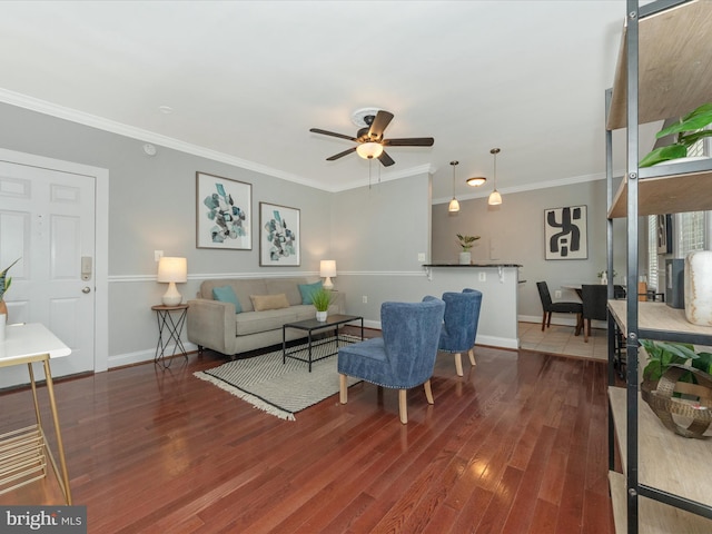 living room with wood-type flooring, ceiling fan, and crown molding