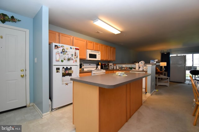 kitchen featuring white appliances and a kitchen island