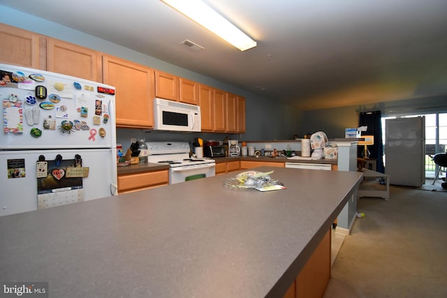 kitchen featuring light brown cabinetry and white appliances