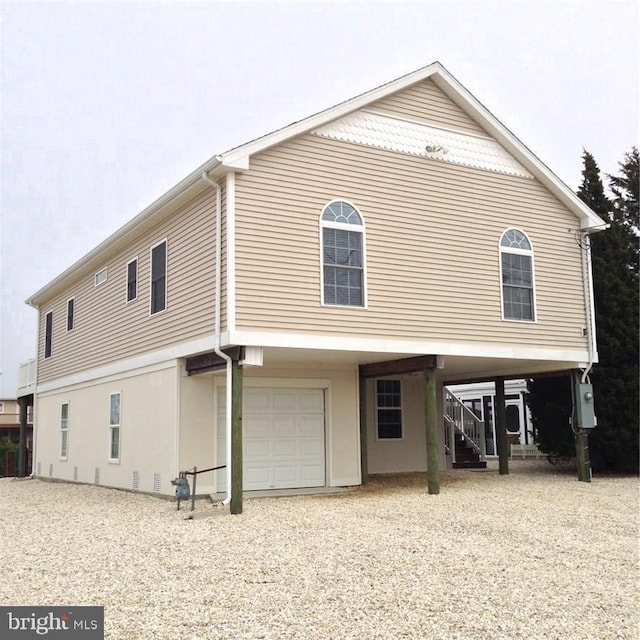 rear view of house featuring a garage