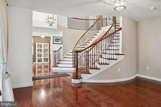 entryway featuring hardwood / wood-style flooring and a chandelier