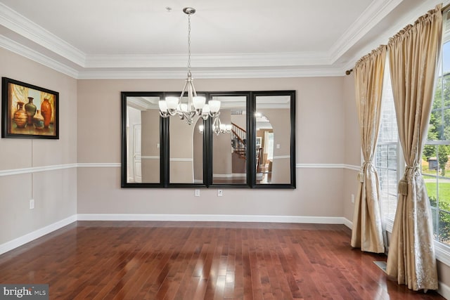 unfurnished dining area featuring ornamental molding, dark hardwood / wood-style floors, and a notable chandelier