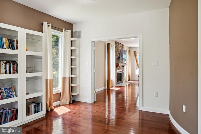 interior space with a fireplace and dark hardwood / wood-style flooring