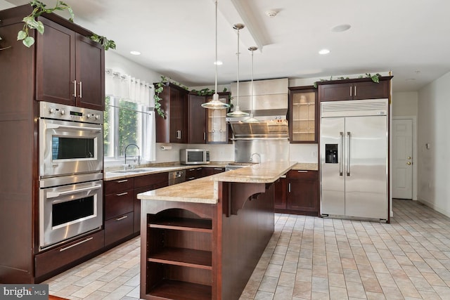 kitchen featuring pendant lighting, sink, stainless steel appliances, a center island, and wall chimney exhaust hood