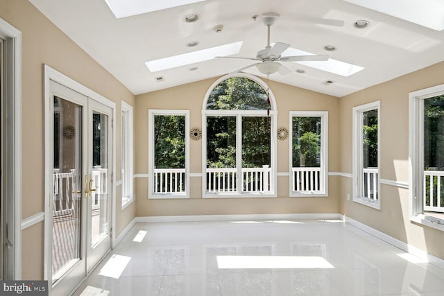 unfurnished sunroom featuring lofted ceiling with skylight, french doors, and a healthy amount of sunlight