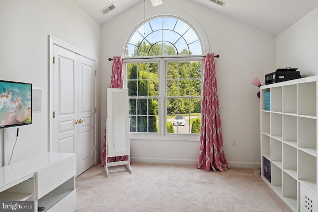 interior space with light colored carpet and vaulted ceiling