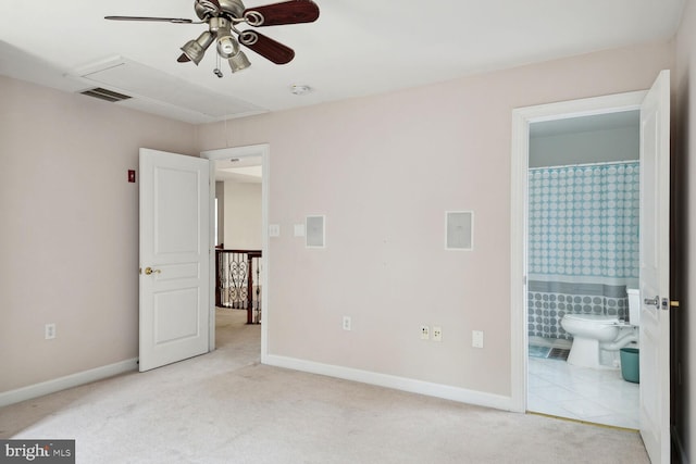 unfurnished bedroom featuring connected bathroom and light colored carpet