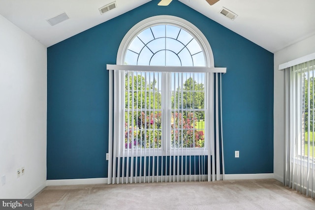 unfurnished room featuring ceiling fan, vaulted ceiling, and light carpet