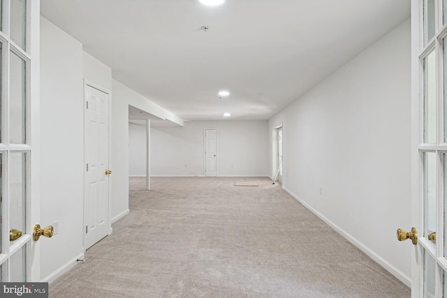 basement featuring light colored carpet