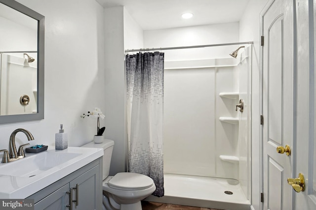 bathroom with vanity, toilet, and a shower with shower curtain