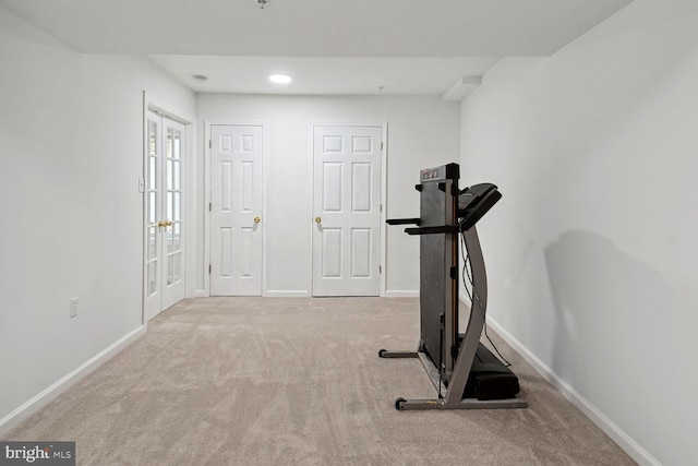 workout area featuring light colored carpet and french doors