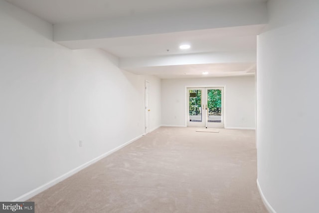 empty room featuring light colored carpet and french doors