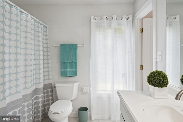 bathroom with vanity, plenty of natural light, and toilet