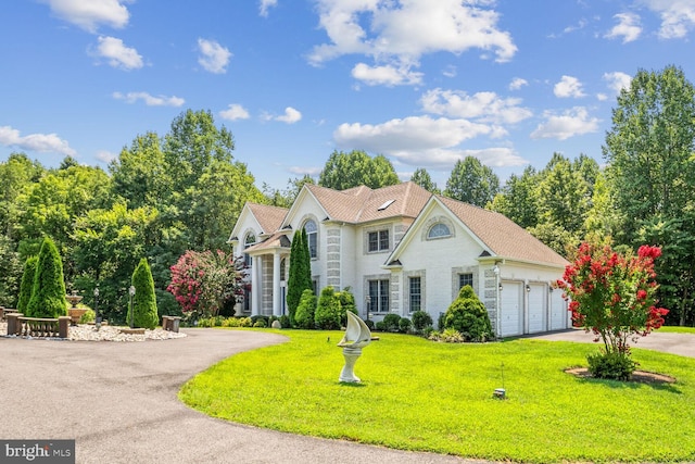 view of front of property featuring a garage and a front lawn