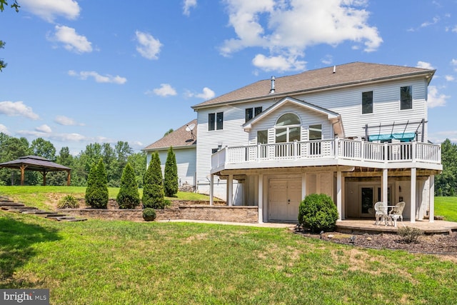 rear view of house featuring a gazebo, a patio, a deck, and a lawn