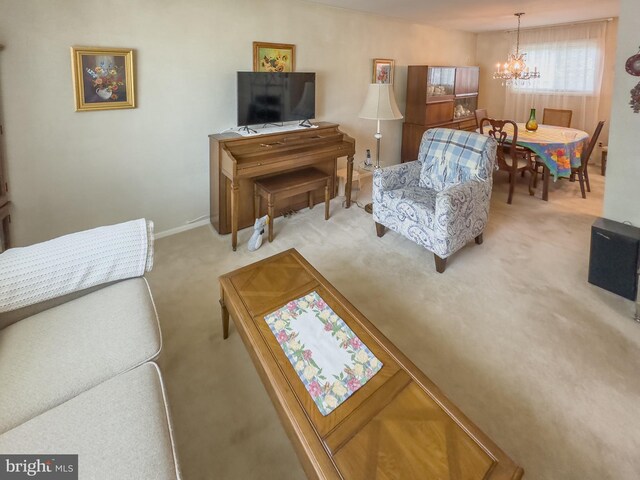 living room with an inviting chandelier and carpet flooring