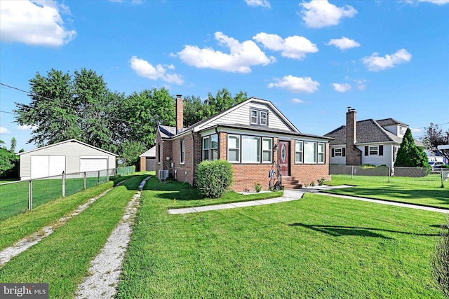 view of front of house with an outdoor structure, a garage, and a front yard