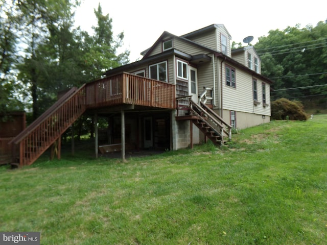 back of house with a deck and a lawn