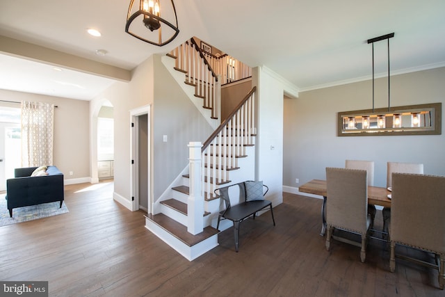 dining area featuring crown molding and dark wood-type flooring