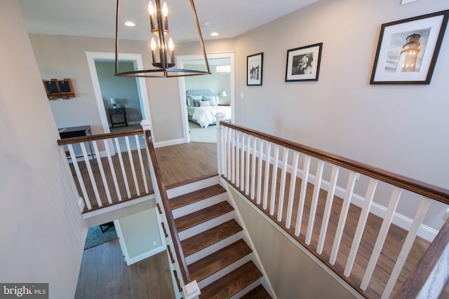 stairs featuring hardwood / wood-style flooring