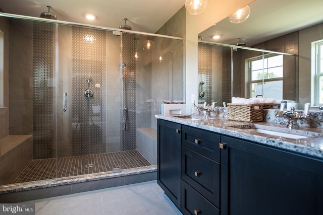 bathroom featuring walk in shower, vanity, and tile patterned flooring