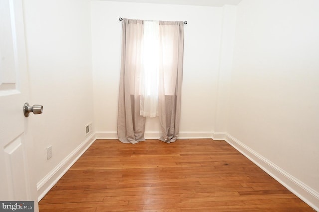 empty room with light hardwood / wood-style flooring