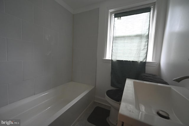 bathroom featuring vanity, toilet, and a wealth of natural light