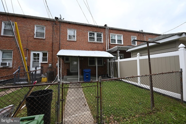 back of property with cooling unit and a lawn