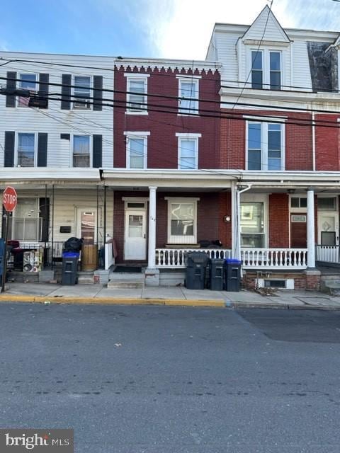 townhome / multi-family property with covered porch