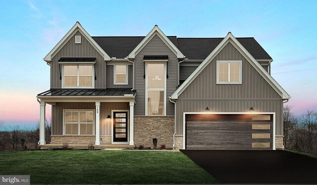 view of front of house featuring a garage and a front lawn