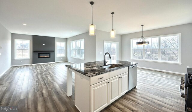 kitchen with light wood-type flooring, electric range, light stone counters, tasteful backsplash, and white cabinetry