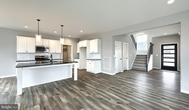 foyer entrance with hardwood / wood-style flooring and plenty of natural light