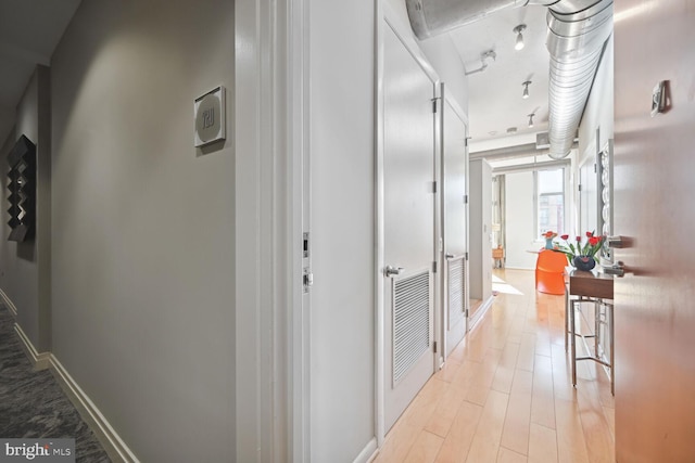 hall with light hardwood / wood-style floors