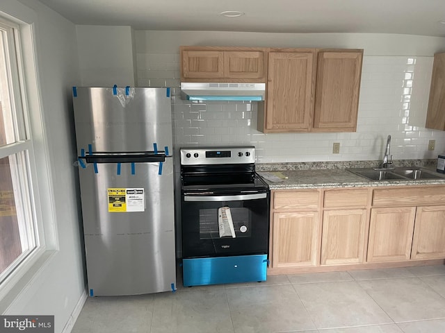 kitchen featuring light tile patterned floors, range hood, decorative backsplash, and stainless steel appliances