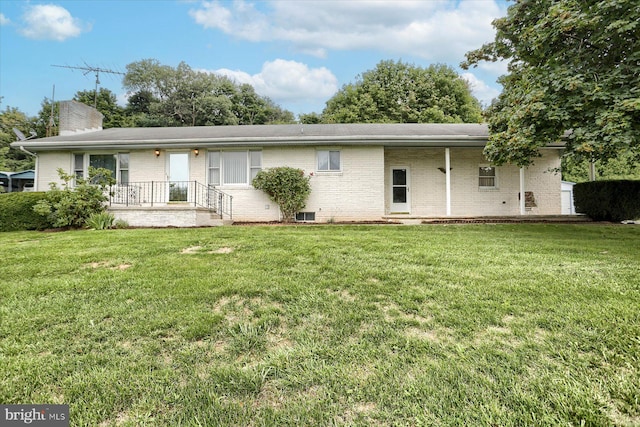 rear view of house with a lawn