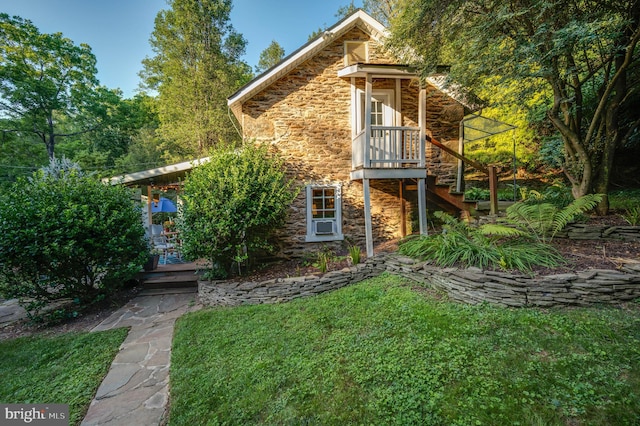 rear view of property with a lawn