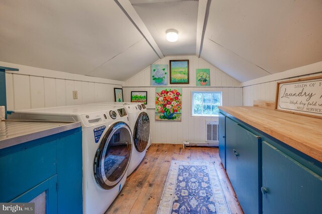 washroom featuring light wood-type flooring, cabinets, and separate washer and dryer