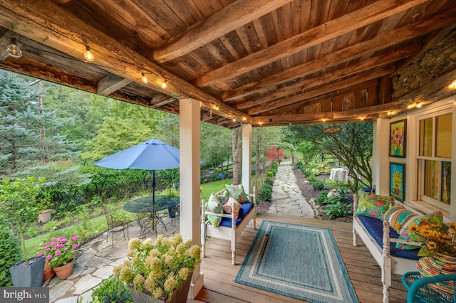 wooden terrace with a patio area