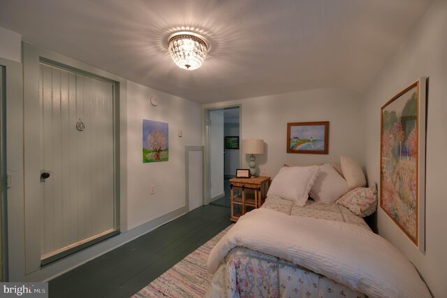 bedroom with dark hardwood / wood-style floors