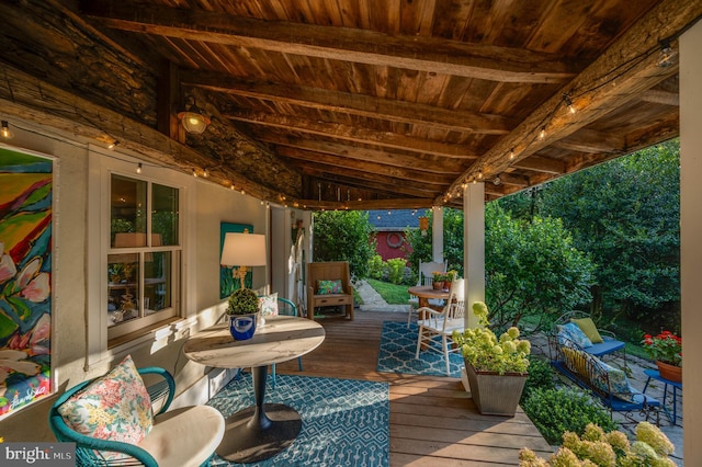 wooden terrace with an outdoor living space