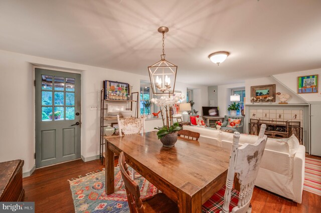 dining space featuring a notable chandelier and dark hardwood / wood-style flooring