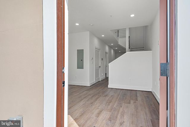 unfurnished living room with light hardwood / wood-style floors and electric panel