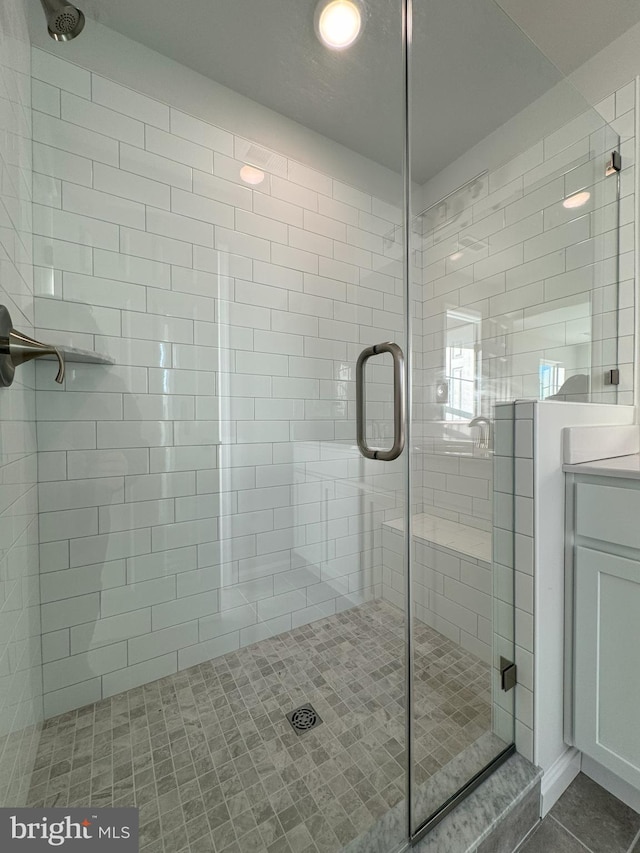 bathroom featuring an enclosed shower and vanity