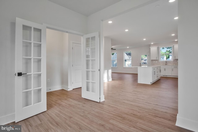 interior space featuring french doors and light hardwood / wood-style floors