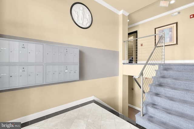 staircase with a mail area, light tile patterned floors, and ornamental molding